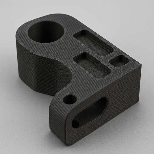 3D-tryckt del i svart, som illustrerar val av 3D material för utskriftsprojekt.